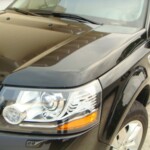 Before and after photographs of a damaged, black, Range Rover that was repaired by Elite Paint & Body Shop in West Palm Beach, FL.